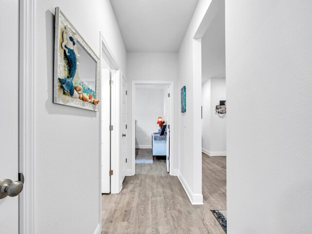 131 W Oak Trees Ln, Freeport, FL 32439 - hallway featuring light wood finished floors and baseboards