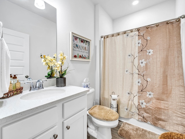 bathroom featuring a shower with curtain, hardwood / wood-style floors, vanity, and toilet