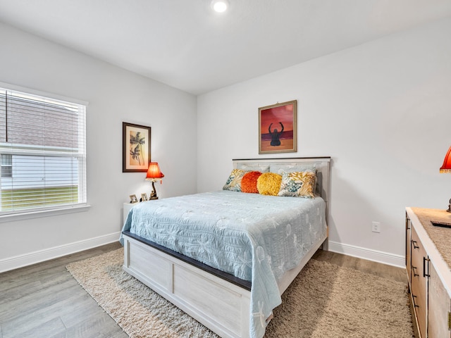 bedroom with wood-type flooring