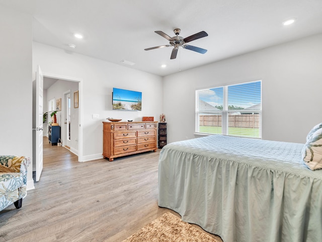 bedroom with light wood-type flooring and ceiling fan