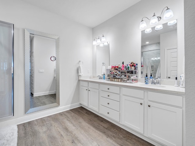 bathroom featuring vanity, an enclosed shower, and hardwood / wood-style flooring