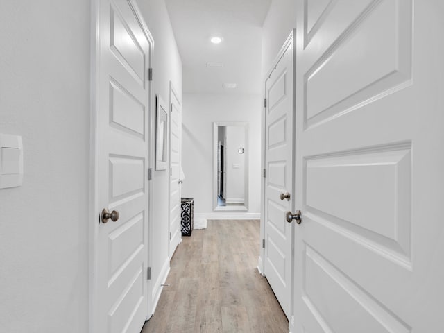 hall with light hardwood / wood-style floors