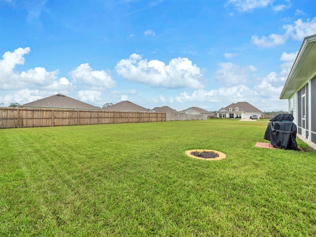 view of yard featuring an outdoor fire pit