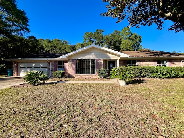 ranch-style house with a garage and a front lawn