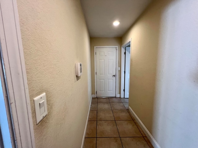 hallway with tile patterned floors