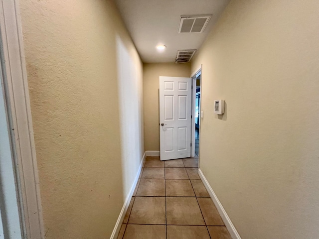 hallway with light tile patterned floors