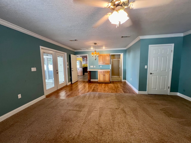 kitchen with crown molding, light hardwood / wood-style flooring, and a textured ceiling