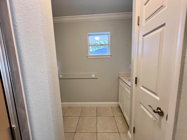 bathroom with tile patterned floors, vanity, and ornamental molding