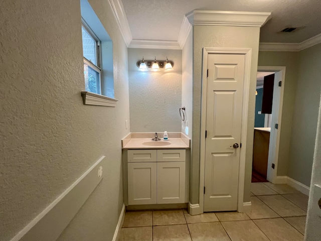 bathroom featuring vanity, tile patterned floors, and crown molding