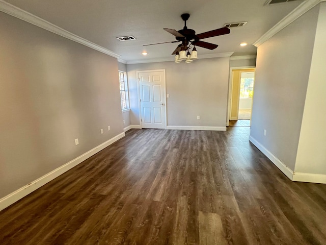 spare room featuring dark hardwood / wood-style floors, ceiling fan, and ornamental molding