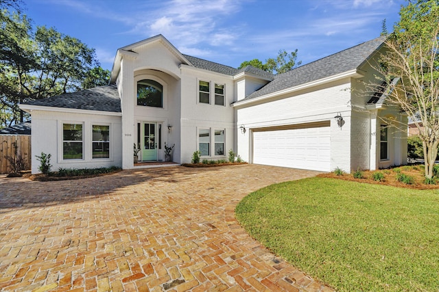 view of front of property featuring a garage and a front lawn