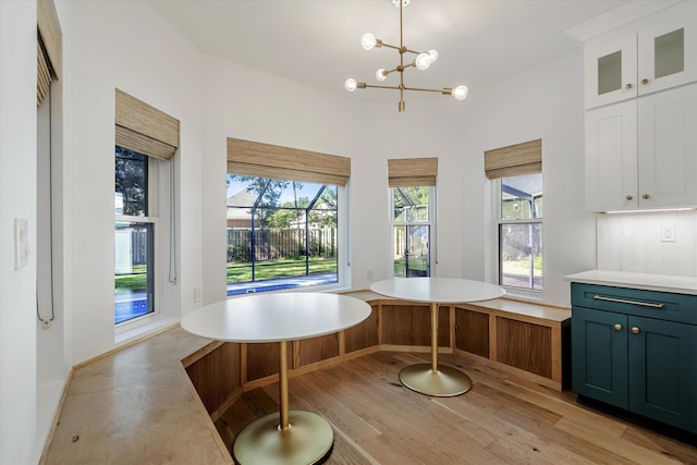 dining room featuring light hardwood / wood-style flooring and a chandelier