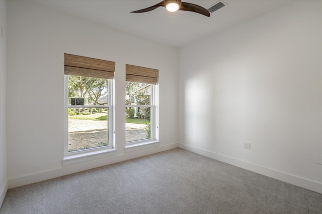 carpeted spare room featuring ceiling fan