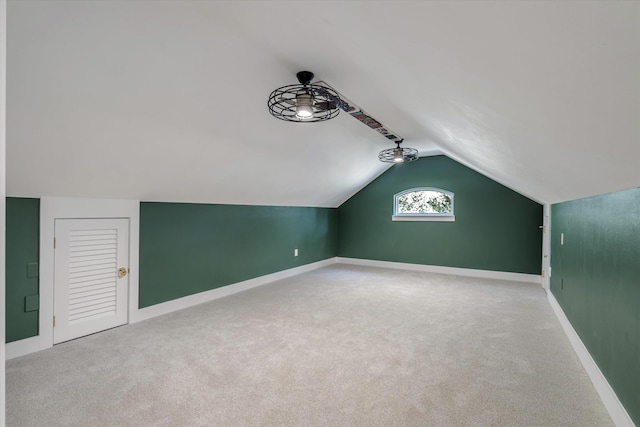 bonus room featuring ceiling fan, carpet floors, and vaulted ceiling