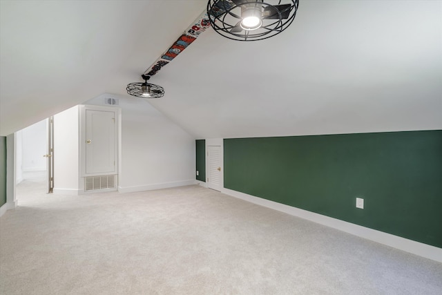 bonus room with light colored carpet and lofted ceiling