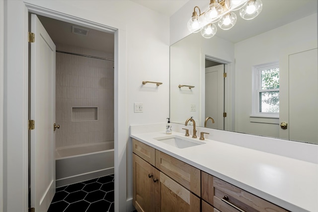 bathroom with tile patterned floors, vanity, and shower / bathtub combination