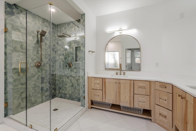 bathroom with tile patterned floors, a shower with door, and vanity