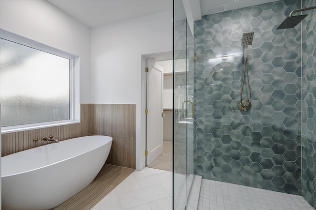 bathroom with shower with separate bathtub and tile patterned floors