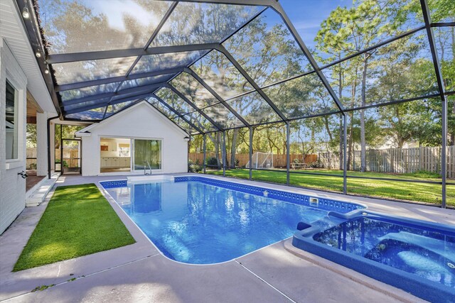 view of swimming pool featuring an in ground hot tub, glass enclosure, a patio area, and a lawn