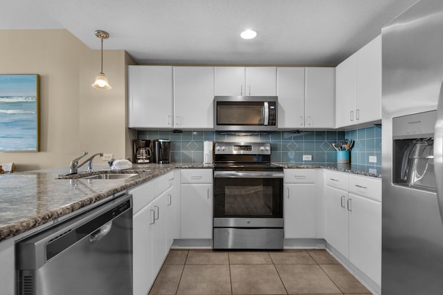 kitchen featuring sink, stainless steel appliances, decorative light fixtures, decorative backsplash, and white cabinets