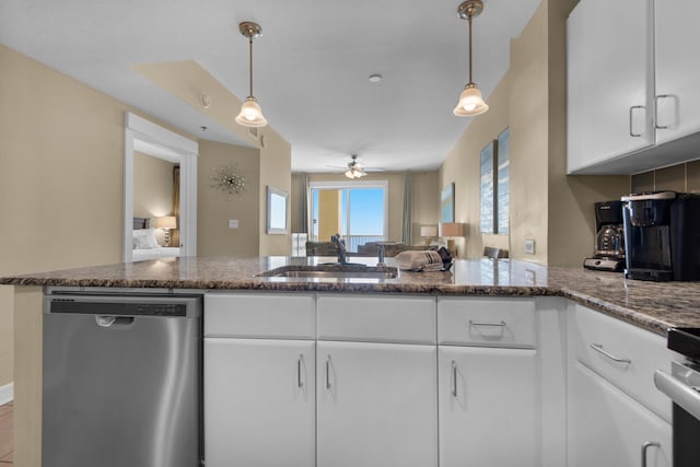 kitchen featuring dishwasher, white cabinets, pendant lighting, and sink