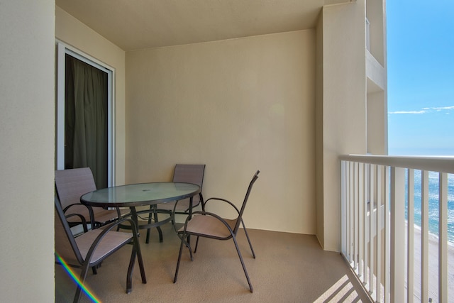 balcony featuring a water view and a beach view