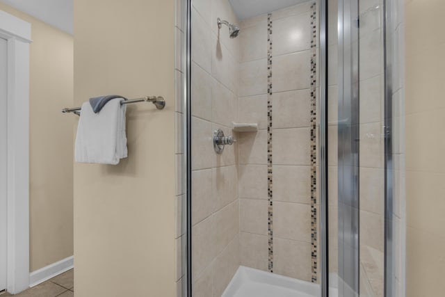 bathroom with tile patterned flooring and an enclosed shower