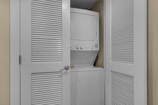 washroom featuring stacked washer and dryer