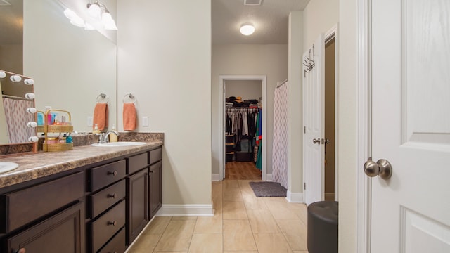 bathroom with vanity and a textured ceiling