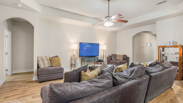 living room with ceiling fan and light wood-type flooring