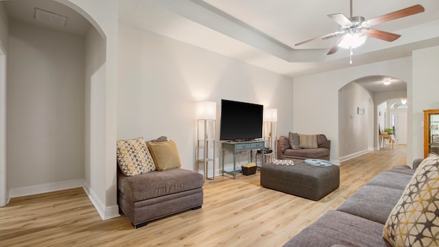 living room with ceiling fan and hardwood / wood-style flooring