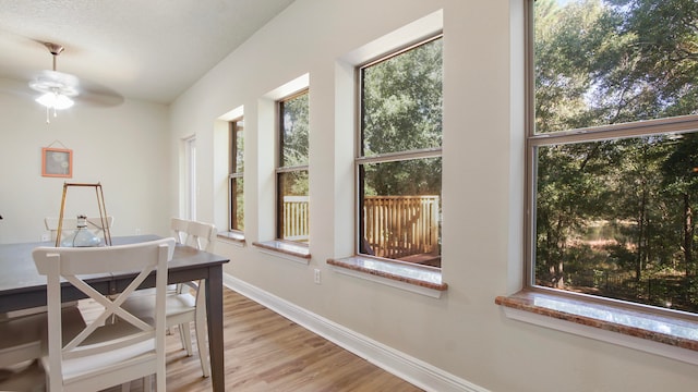 sunroom / solarium featuring ceiling fan