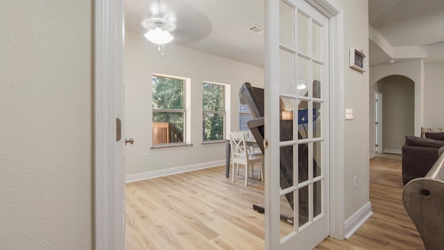 446 Mango Ln, Freeport, FL 32439 - hallway with arched walkways and wood finished floors