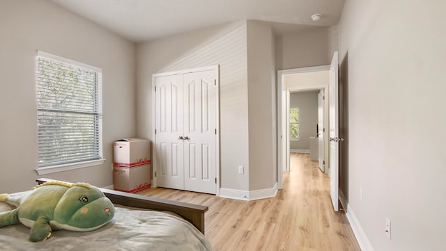 bedroom with a closet and light hardwood / wood-style flooring