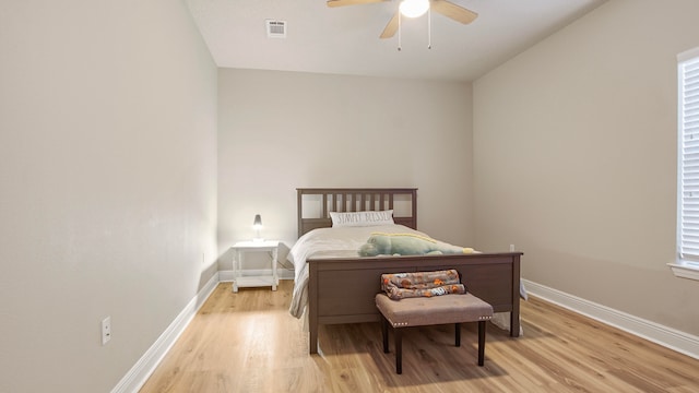 bedroom with light hardwood / wood-style floors and ceiling fan