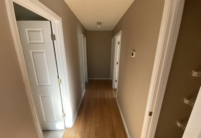 corridor with light hardwood / wood-style floors