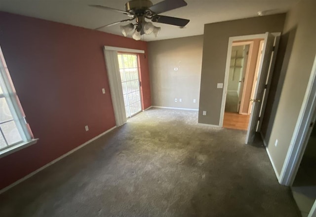 carpeted empty room featuring ceiling fan