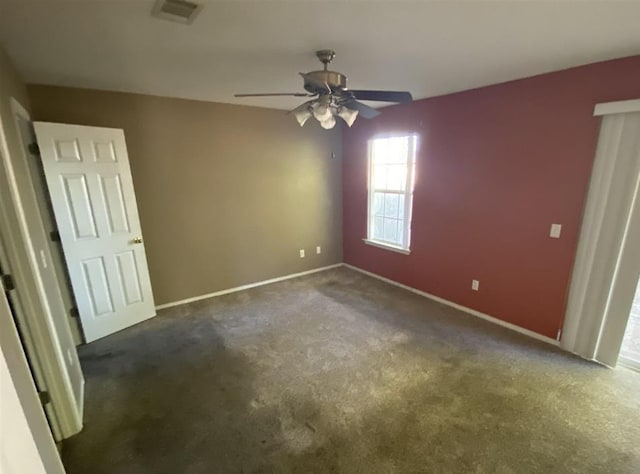 carpeted empty room featuring ceiling fan