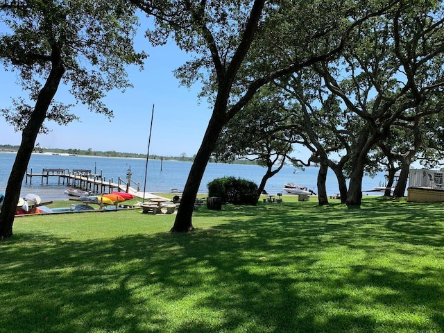 view of yard featuring a dock and a water view