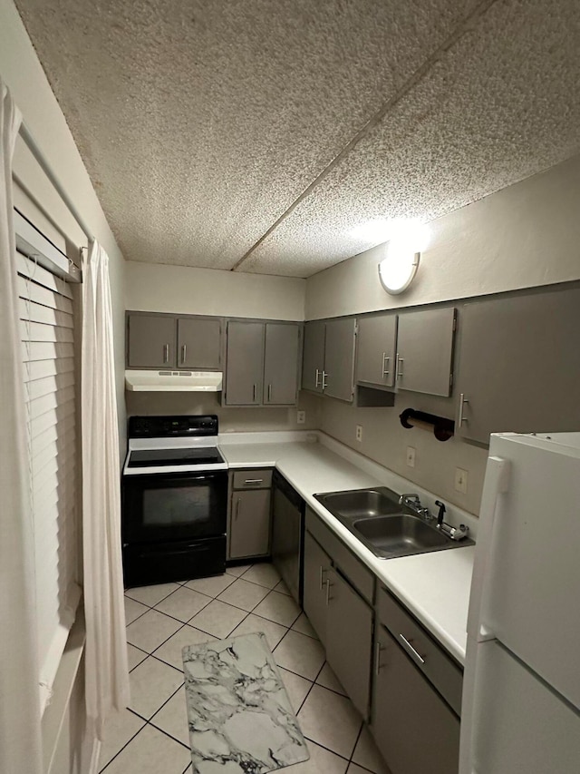 kitchen with gray cabinetry, sink, light tile patterned flooring, and white appliances