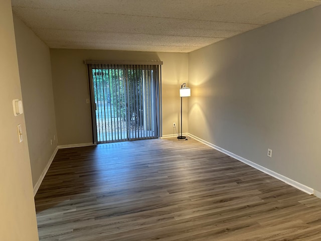 spare room with dark hardwood / wood-style flooring