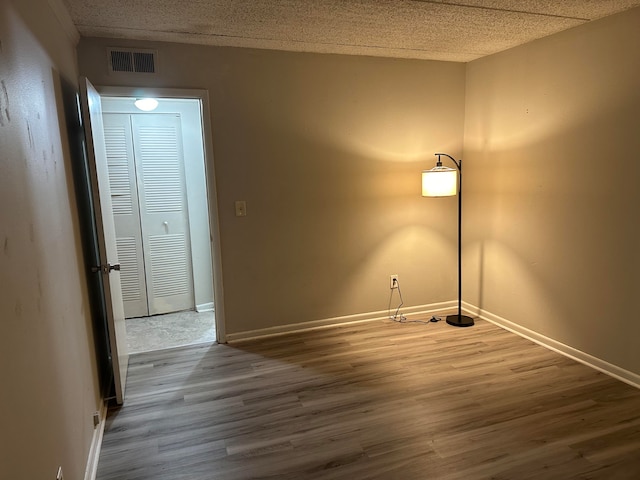 spare room featuring wood-type flooring