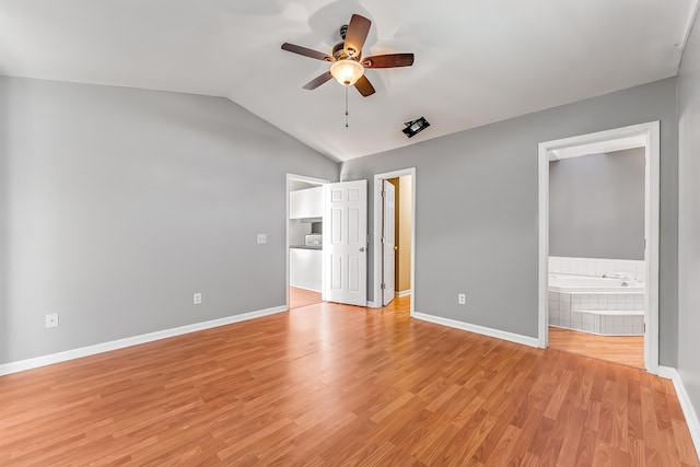 unfurnished bedroom with vaulted ceiling, light hardwood / wood-style floors, ensuite bath, and ceiling fan