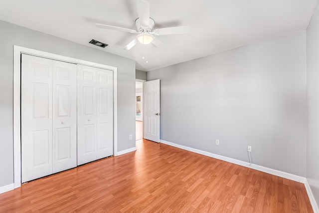 unfurnished bedroom with a closet, ceiling fan, and light hardwood / wood-style flooring