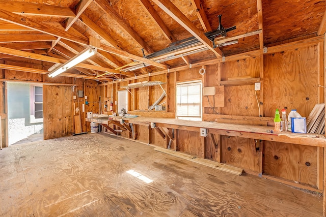 miscellaneous room featuring a workshop area and vaulted ceiling