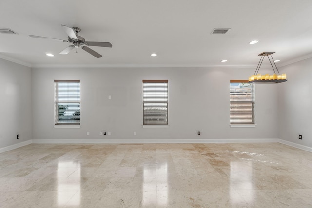 spare room featuring ceiling fan with notable chandelier, a wealth of natural light, and crown molding