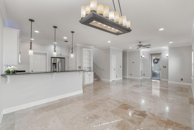 unfurnished living room with ceiling fan and crown molding