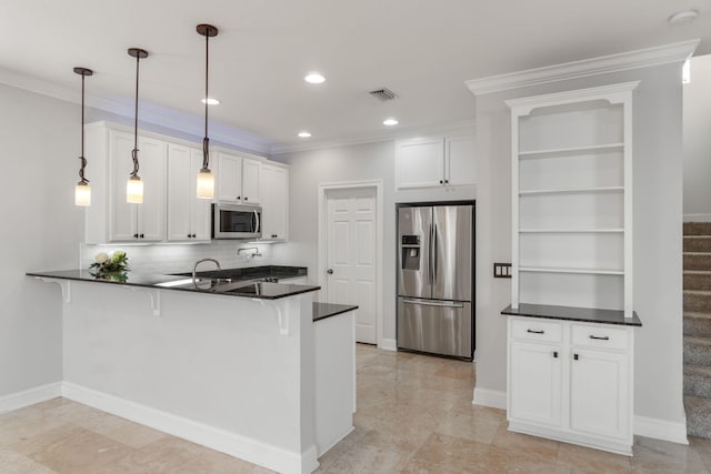 kitchen featuring pendant lighting, white cabinets, kitchen peninsula, and appliances with stainless steel finishes