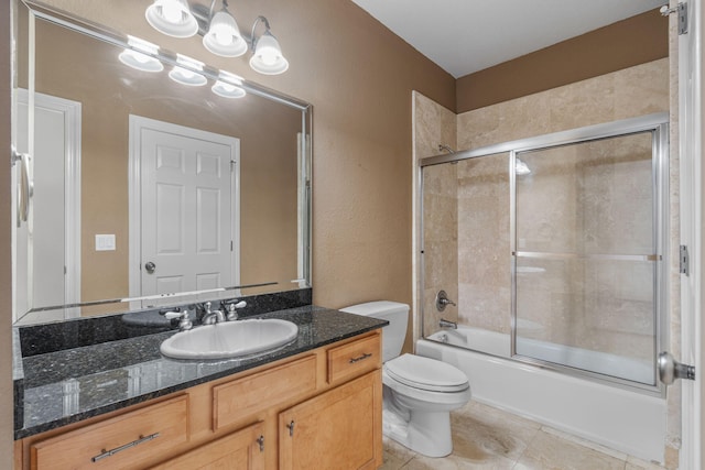 full bathroom with tile patterned flooring, toilet, combined bath / shower with glass door, and vanity