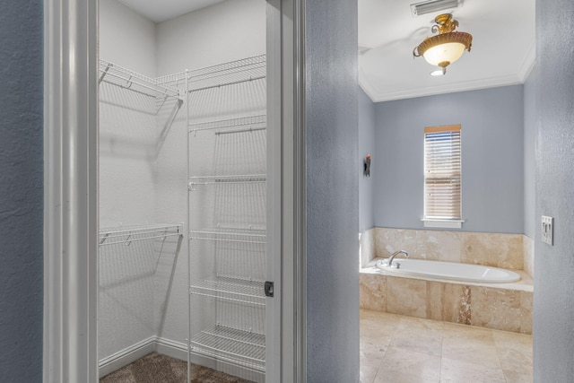 bathroom featuring tiled tub and ornamental molding